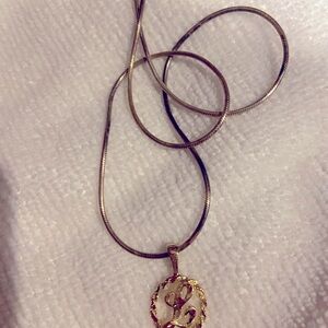 10k gold pendant and chain. Letter L within design